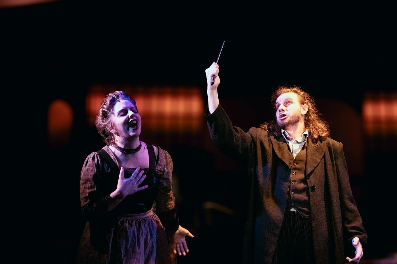 Production of Sweeney Todd featuring Ms. Lovett and Sweeney Todd holding up straight razor singing	